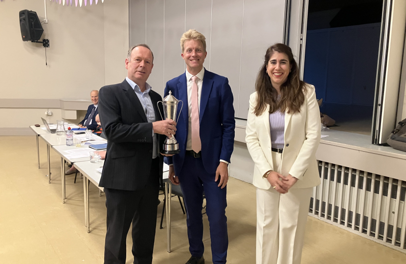 Neva Novaky and Ben Spencer present a cup to Oatlands Branch Chair Ben White