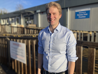 Dr Ben Spencer MP outside the temporary health centre buildings in Weybridge